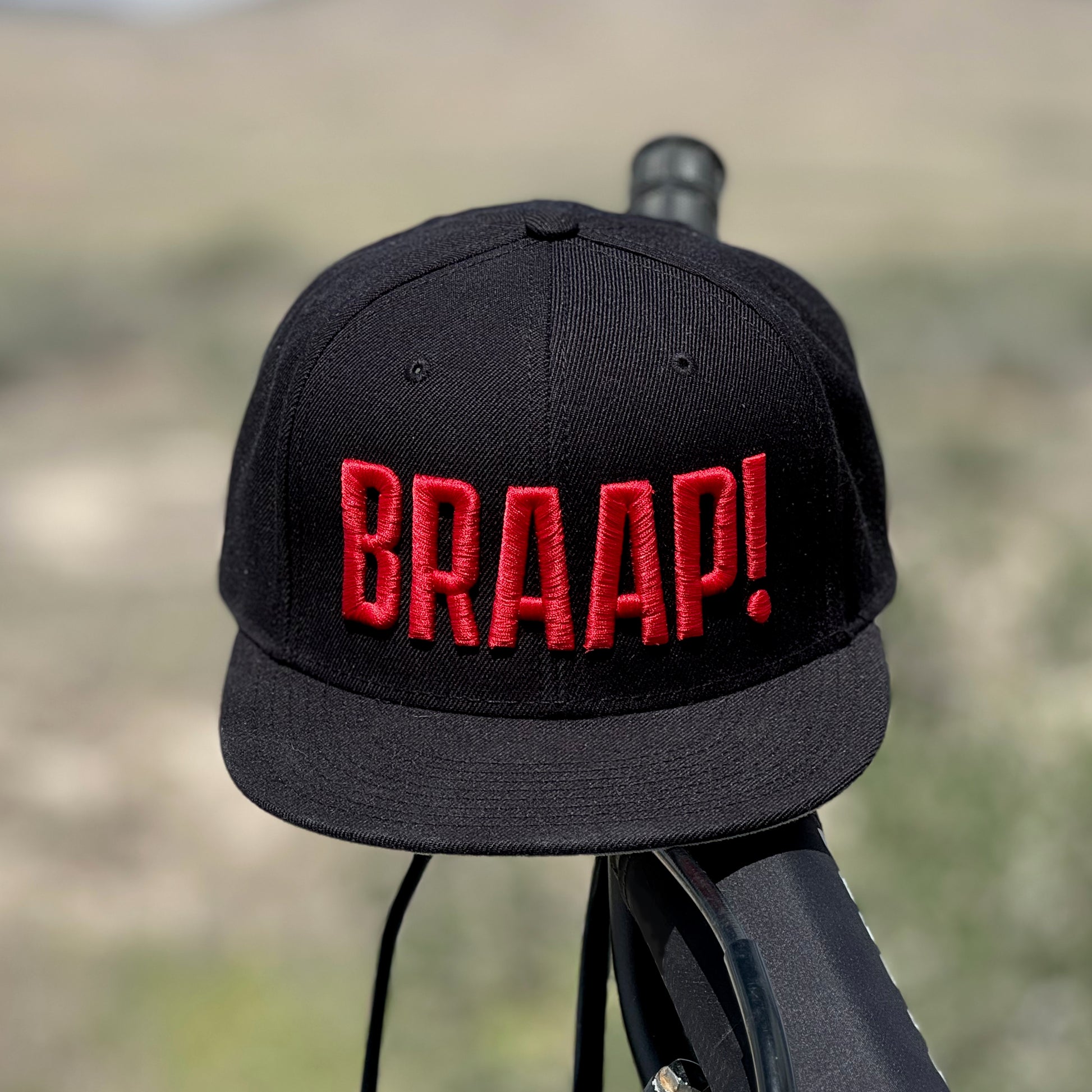 Black hat with red embroidered BRAAP! on the front